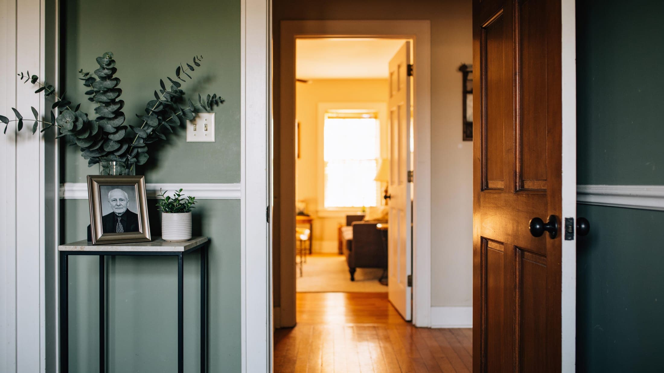 An open door in a warm home with soft light beyond.